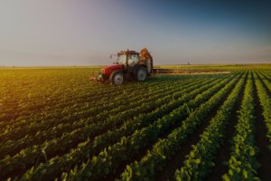 tractor in field at sunrise